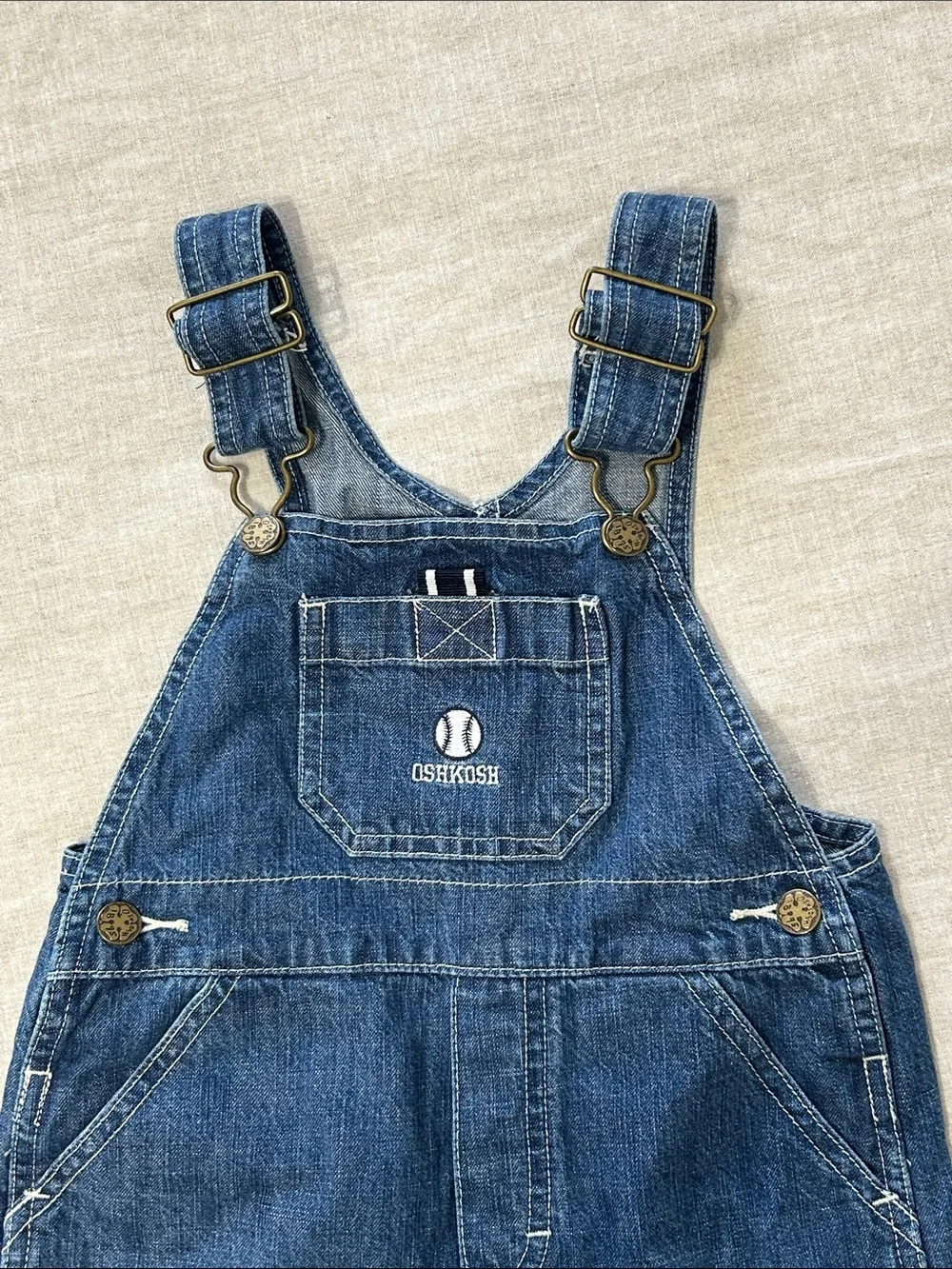 OshKosh B'gosh Dark Blue Denim Short Overalls for Kids. Embroidered baseball.